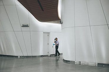 cleaner cleaning floor with wide mop