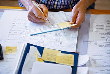 person reviewing calculations on paper